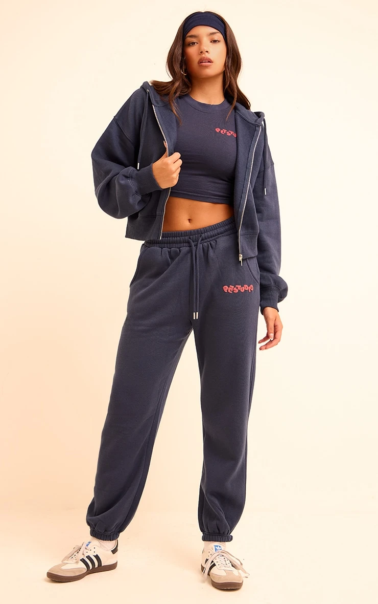 Prettylittlething Midnight Blue PLT Studio Archive Puff Print Drawstring Cuffed Sweatpants 1 Prettylittlething Midnight Blue PLT Studio Archive Puff Print Drawstring Cuffed Sweatpants