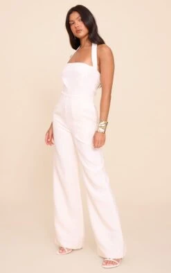 Prettylittlething Cream Premium Woven Halter Neck Wide Leg Jumpsuit -Pretty Little Thing Shop b66de5f720e553c52afecb7ef5e0be2894bd3e2f CNN4822 3 cream premium woven halter neck wide leg jumpsuit