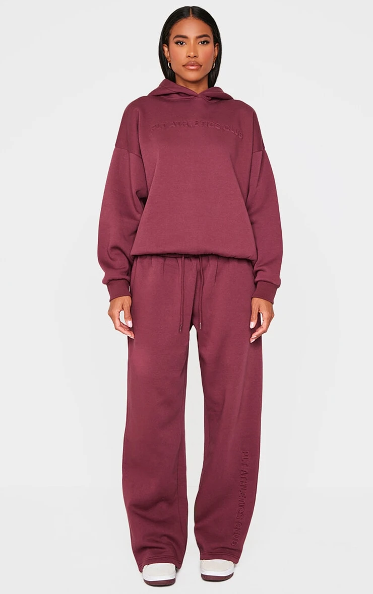 PRETTYLITTLETHING Burgundy Athletics Club Embossed Straight Leg Sweatpants 1 PRETTYLITTLETHING Burgundy Athletics Club Embossed Straight Leg Sweatpants